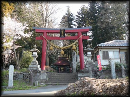 吾妻神社境内正面に設けられた朱色の大鳥居と石造燈篭と石造社号標